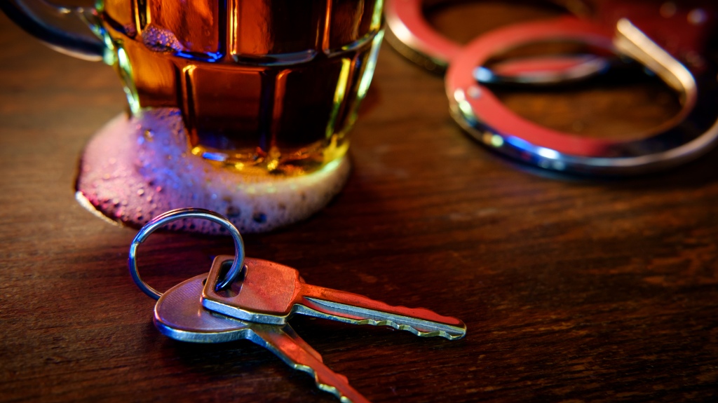 mug of beer with handcuffs and keys